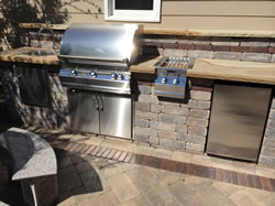 A beautiful outdoor kitchen with a grill