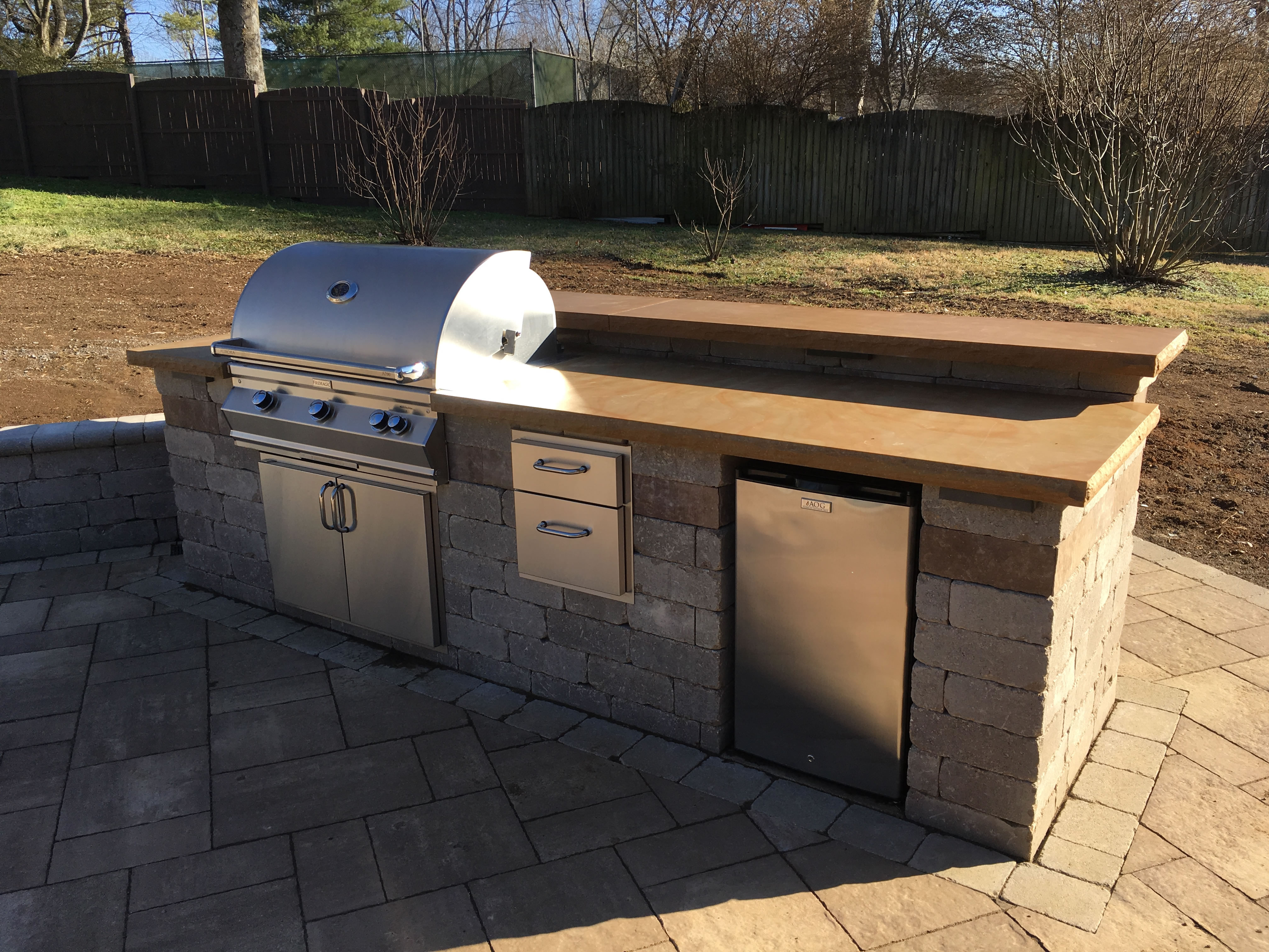 Outdoor grill on paver deck.