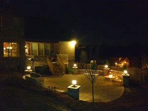 An outdoor patio area with outdoor lighting all around