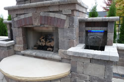 A beautiful outdoor waterwall and fireplace
