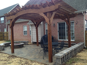 A nice new wood pergola over a backyard patio